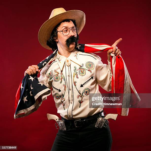 american cowboy portrait with flag pointing and raised eyebrow - western shirt stockfoto's en -beelden