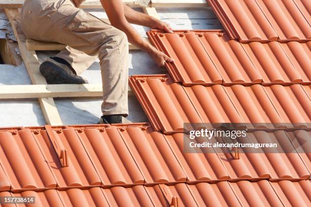 man working on the roof - shingle roof stock pictures, royalty-free photos & images