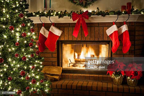christmas fireplace, tree, and decorations - red stockings stock pictures, royalty-free photos & images
