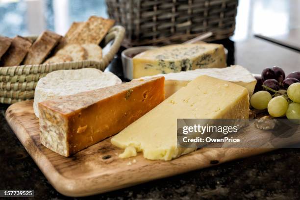 selection of english and french cheese on rustic board - ostbricka bildbanksfoton och bilder
