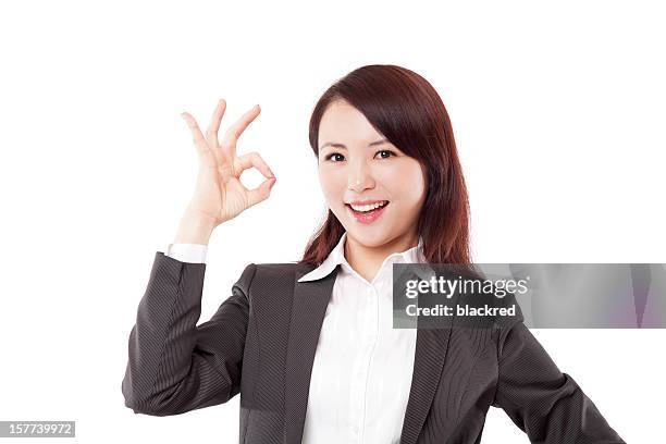 chinese businesswoman showing ok sign on white background - ok sign stock pictures, royalty-free photos & images