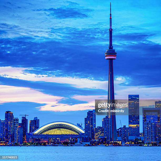 toronto cityscape with cn tower and baseball stadium at dusk - cn tower stock pictures, royalty-free photos & images