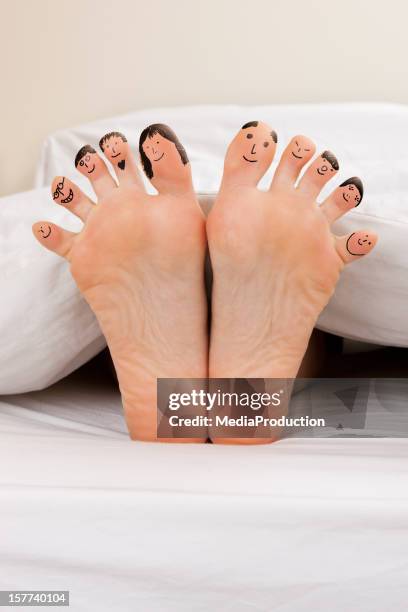 happy feet - male feet on face stock pictures, royalty-free photos & images