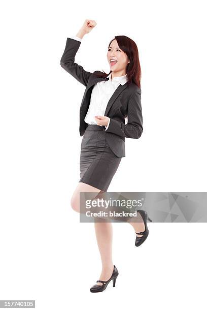 attractive chinese businesswoman celebrating arm rised on white background - business people cheering stockfoto's en -beelden