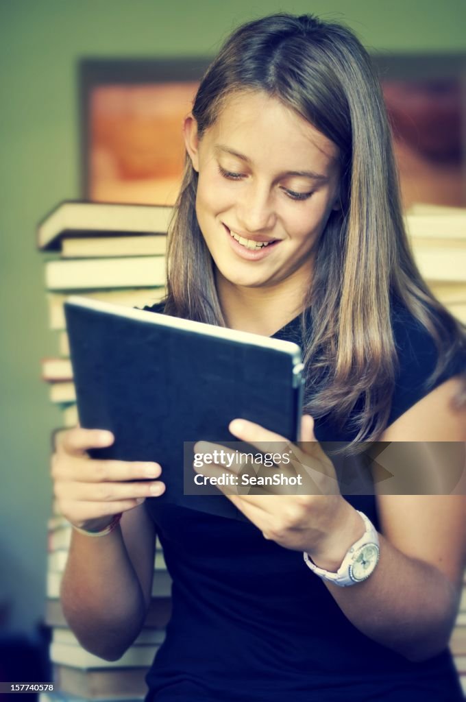 Teenager in Library Using a Tablet