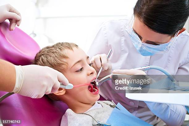 young dental patient in surgery - suction tube stock pictures, royalty-free photos & images