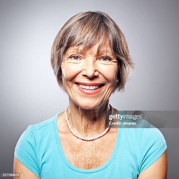 portrait of a friendly smiling senior woman - fine art portrait stockfoto's en -beelden