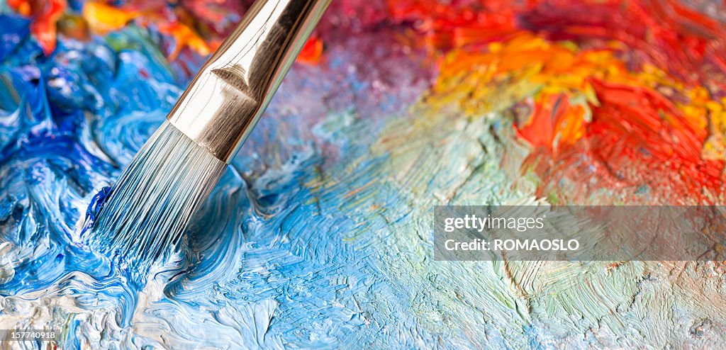 Paintbrush with oil paint on a classical palette