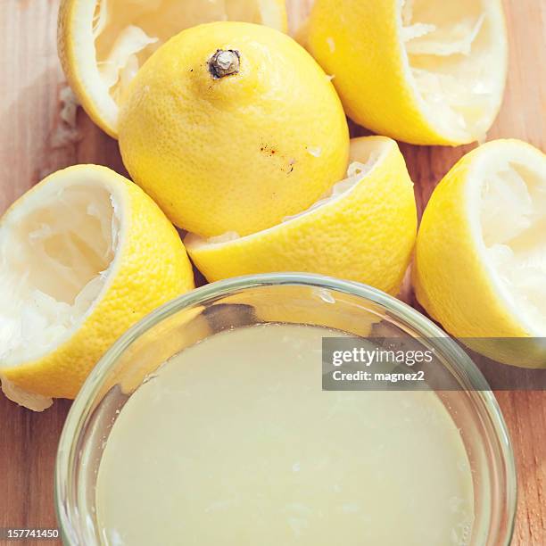 fresh lemons with lemon juice - lemon juice stock pictures, royalty-free photos & images