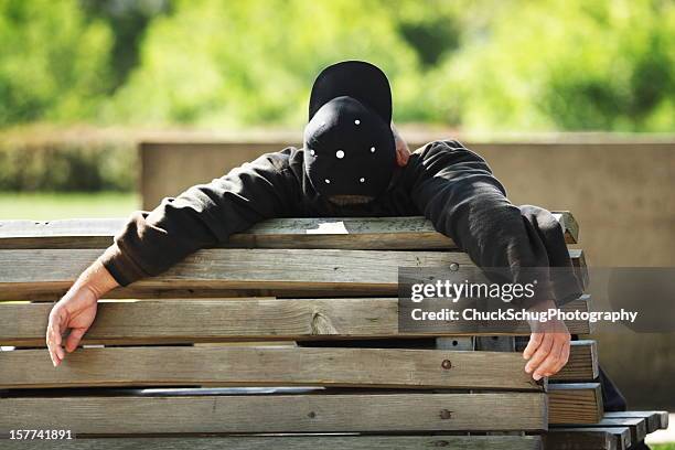 man sleeping park bench nap - man sleeping with cap stock pictures, royalty-free photos & images