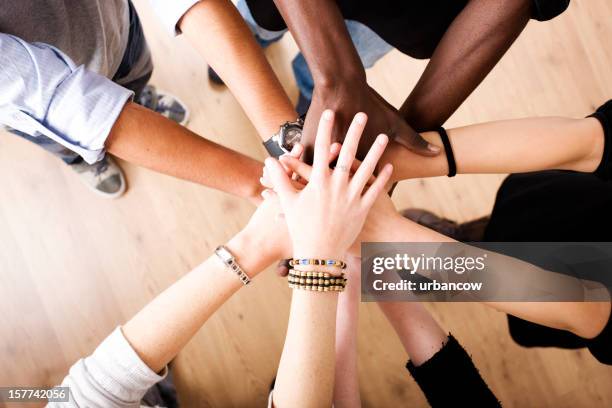 hands in unity - hands together stock pictures, royalty-free photos & images