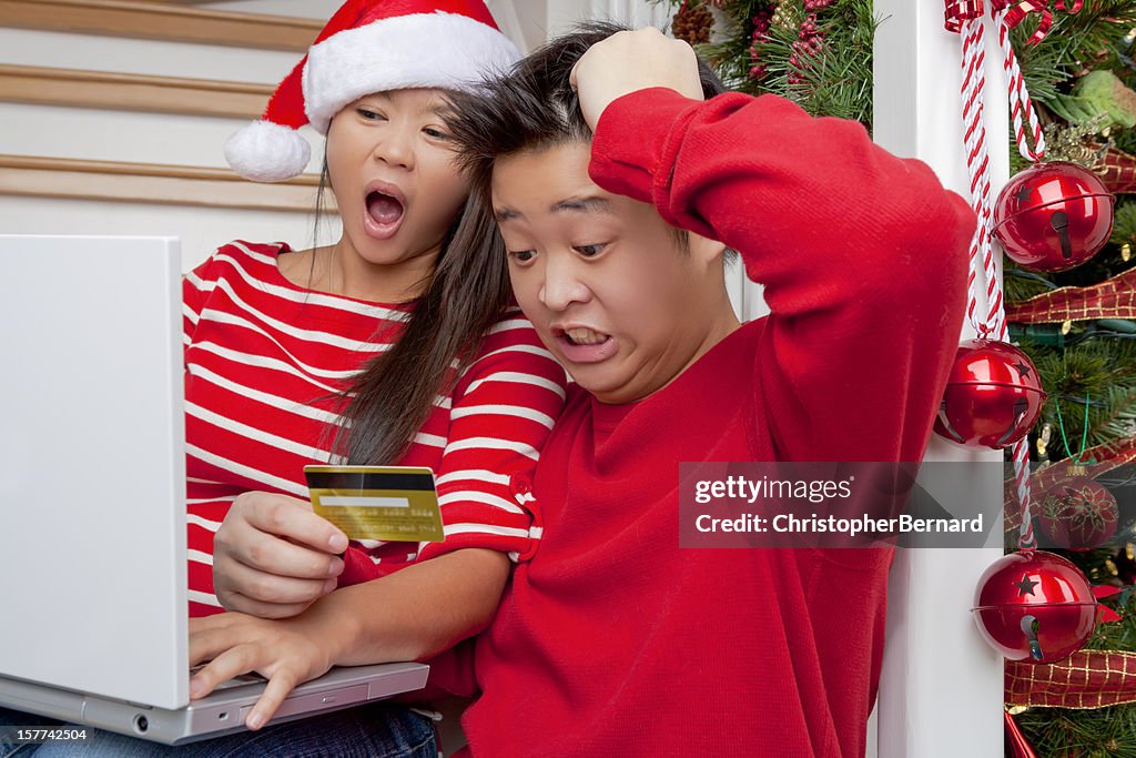 Shocked asian couple christmas online shopping