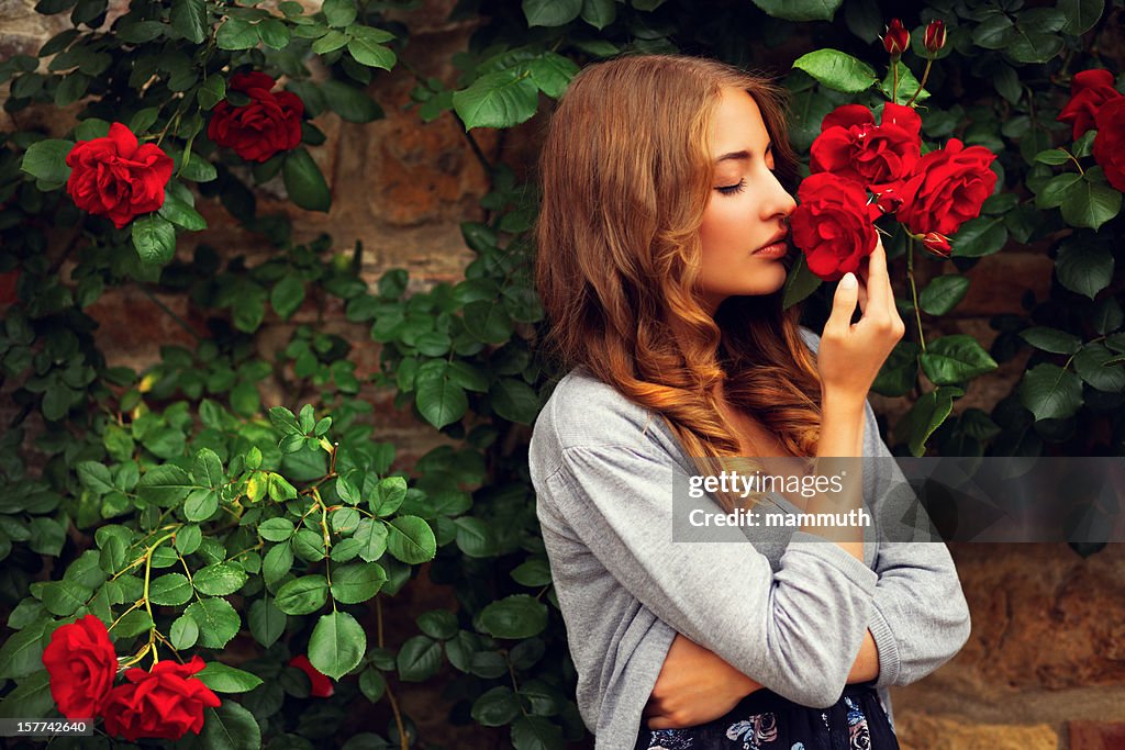 Girl Smelling Roses High-Res Stock Photo - Getty Images