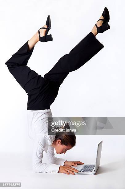 businesswoman doing acrobatics on laptop - young contortionist stockfoto's en -beelden