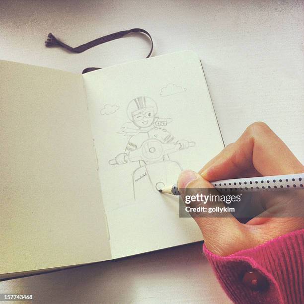 artist sketching girl and scooter with pencil on sketch book - dog pad stock pictures, royalty-free photos & images