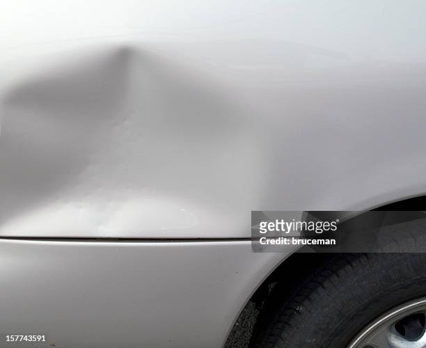 close-up of a dent in a gray car exterior - car deuk stockfoto's en -beelden