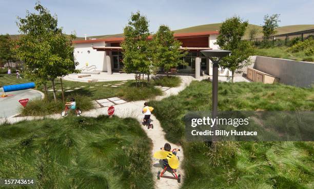 school playground filled green grass and trees - school yard stock pictures, royalty-free photos & images
