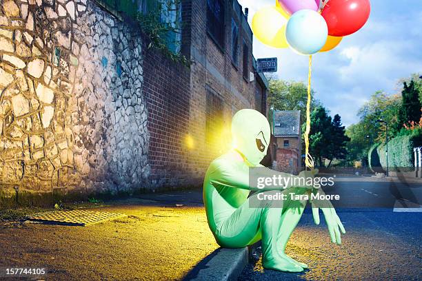 alien sitting in street with balloons - lustig bunt bildbanksfoton och bilder