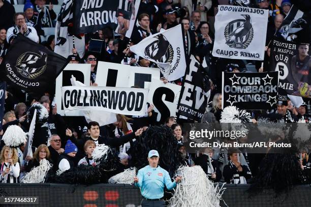 Collingwood fans celebrate during the 2023 AFL Round 21 match between the Hawthorn Hawks and the Collingwood Magpies at Melbourne Cricket Ground on...