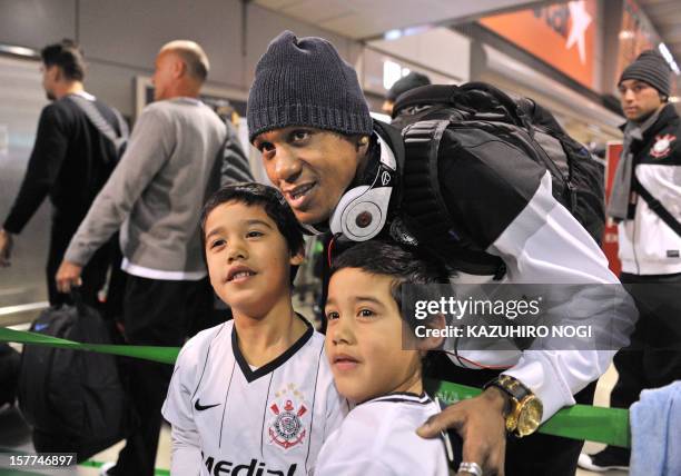 Corinthians football midfielder Edenilson poses with fans for a photograph upon arrival for the Club World Cup at Narita airport on December 6, 2012....