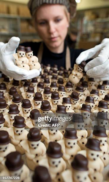 An Employee of Confiserie Felicitas GmbH prepares marzipan snowmen in Hornow, eastern Germany on December 4, 2012. For the production is only used...