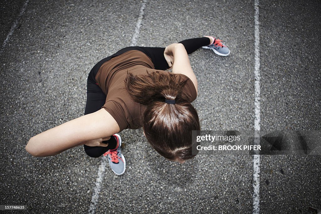 Young woman athlete stretching