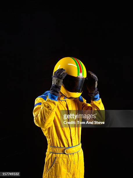racing driver with hands to head in disappointment - racing suit stock pictures, royalty-free photos & images