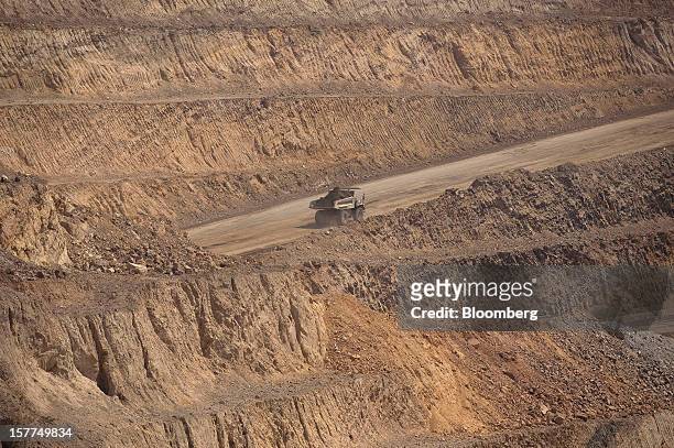 Ore is driven to a processing plant in a Caterpillar Inc. Mining truck after being excavated from an open pit at Katanga Mining Ltd.'s KOV copper and...