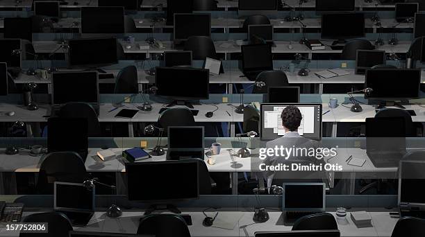 an office worker sits working in an empty office - 空白 個照片及圖片檔