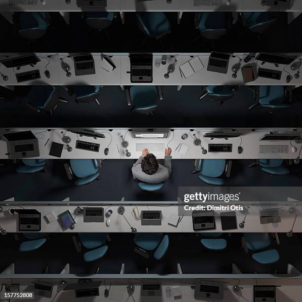 One office worker working in an empty, dark office