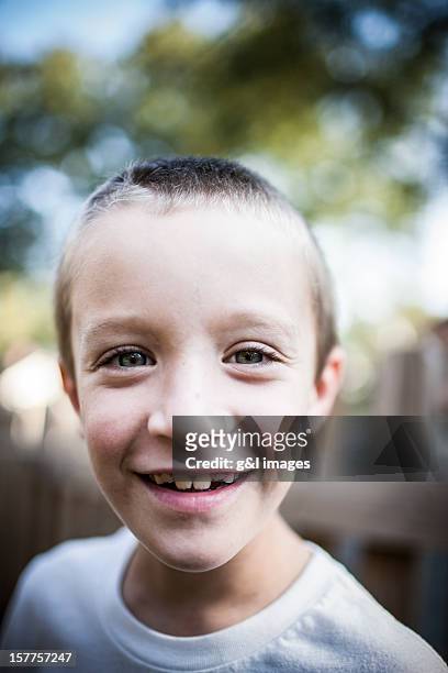boy (8ys) smiling, outdoors - boy face happy stock illustrations