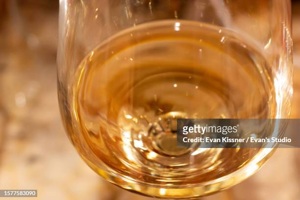 golden white wine in a glass - evan kissner stock pictures, royalty-free photos & images