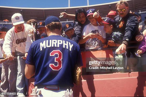Dale Murphy of the Atlanta Braves signs autographs before a baseball game against the San Francisco Giants on June 16, 1990 at Candlestick Park in...