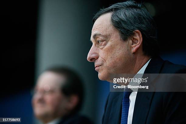 Mario Draghi, president of the European Central Bank , right, speaks during a news conference at the bank's headquarters in Frankfurt, Germany, on...