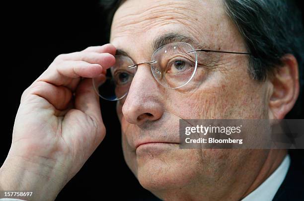 Mario Draghi, president of the European Central Bank , adjusts his spectacles during a news conference at the bank's headquarters in Frankfurt,...
