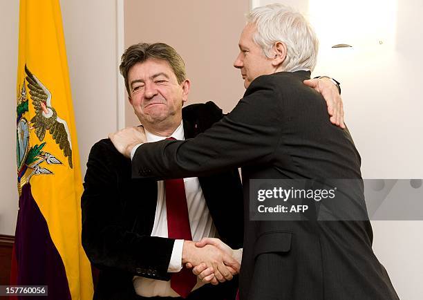 Wikileaks founder Julian Assange shakes hands with French politician Jean Luc Melenchon as Ecuadorian Ambassador Ana Amlma looks on inside the...