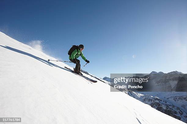 skier riding downhill - skiing foto e immagini stock