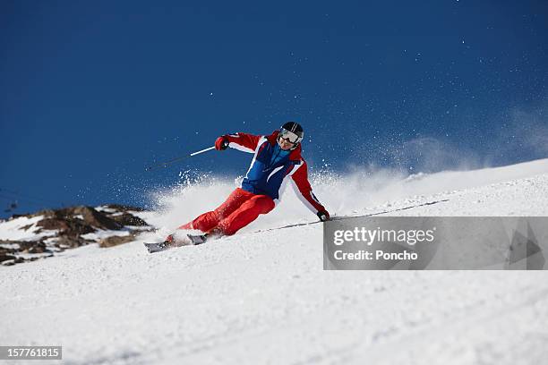 man skiing down a piste - pantaloni da sci foto e immagini stock