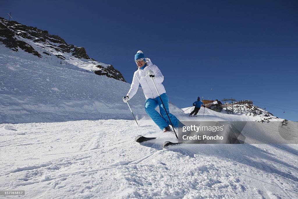 Woman skiing down a piste