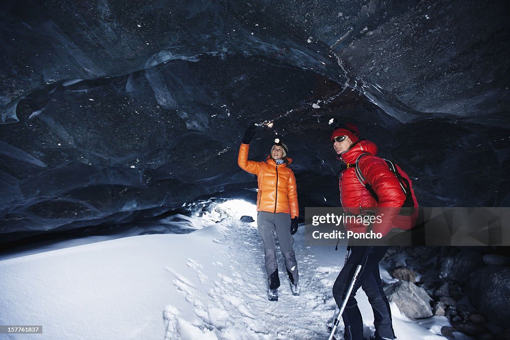 Two women exploring a ice cave