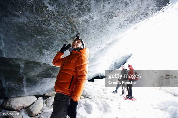 people exploring ice cave - racchetta da neve attrezzatura sportiva foto e immagini stock