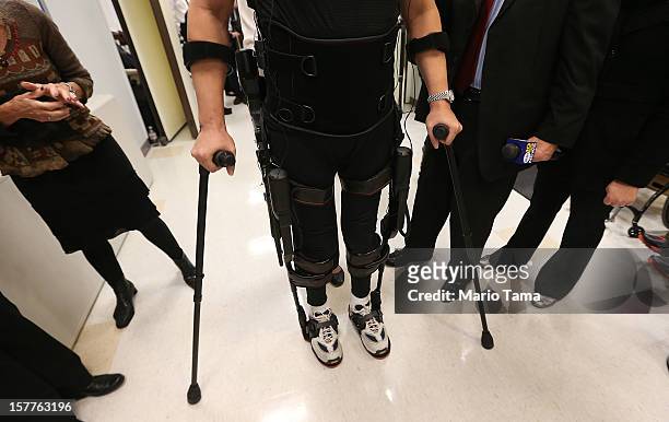 Forty three-year-old parapalegic Robert Woo stands while walking with an exoskeleton device made by Ekso Bionics during a demonstration at the...