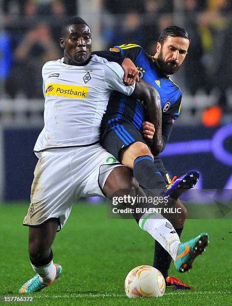 Borussia Monchengladbach's Paniel Mlapa vies with Fenerbahce's Ozgur Cek during the UEFA Europa League Group C3 football match between B....