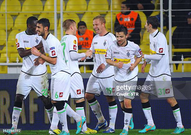 Borussia Monchengladbach's Mike Hanke is congratulated by teammates after he scored the second goal during the UEFA Europa League football match...