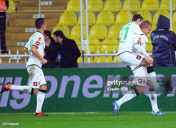 Borussia Monchengladbach's Mike Hanke is congratulated by teammates after he scored during the UEFA Europa League football match between Fenerbahce...