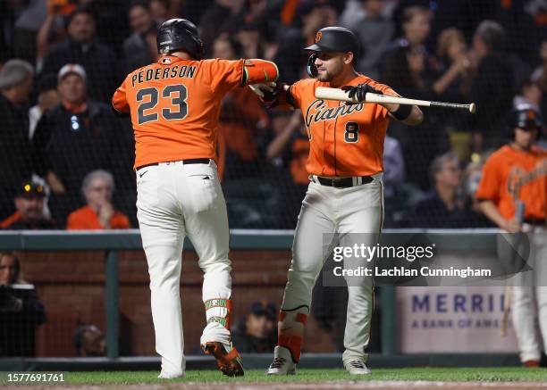 Joc Pederson of the San Francisco Giants celebrates with Michael Conforto after hitting a solo home run in the bottom of the eighth inning against...