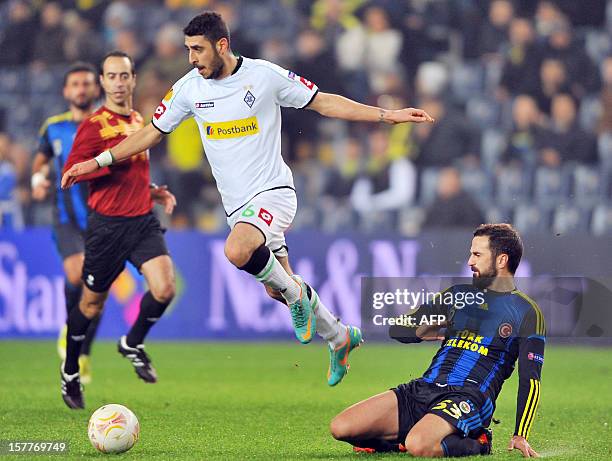 Borussia Monchengladbach's Tolga Cigerci vies with Fenerbahce`s Serdar Kesimal during the UEFA Europa League football match against Fenerbahce SK on...