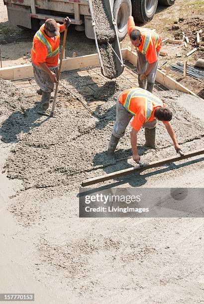 elevated view of three builders working with concrete - cement construction stock pictures, royalty-free photos & images