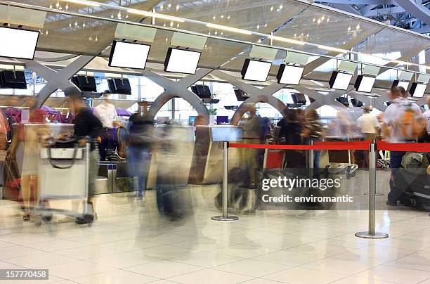 travellers queing to check-in at an international airport. - suvarnabhumi airport stock pictures, royalty-free photos & images