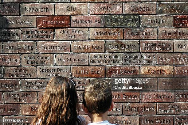 two children looking at the cavern wall of fame - the cavern liverpool stockfoto's en -beelden